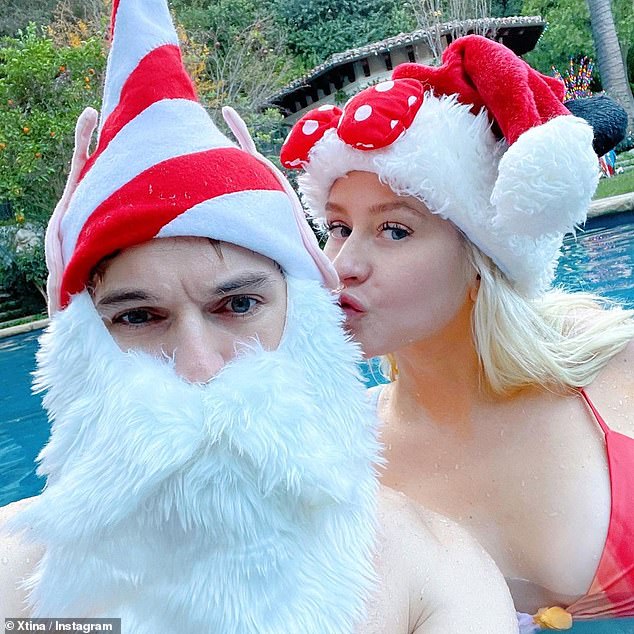Mrs. Claus: The 40-year-old wore a Minnie Mouse Santa hat with her swimsuit while she was walking around Rutler, 25, in the pool, and wrote: 