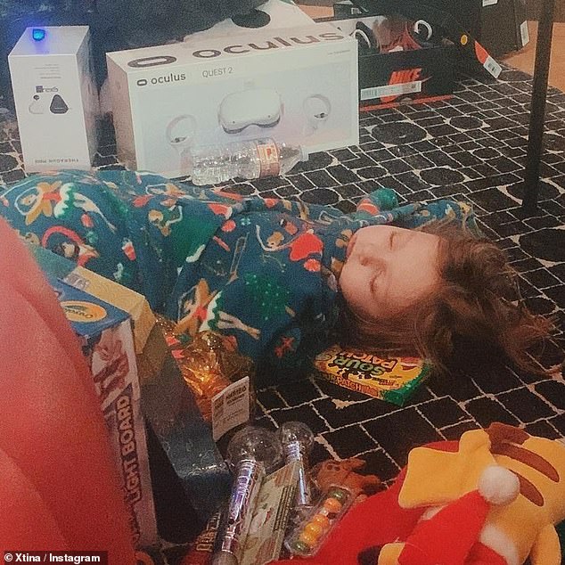 Swooned: Christina also shared a sweet photo of their six-year-old daughter, Summer Rain, wearing her pajamas on the floor after the inaugural gifts