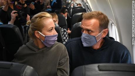 Russian opposition leader Alexei Navalny, right, and his wife Yulia Navalnia, aboard an airline's Pobeda plane bound for Moscow before taking off from Berlin on Sunday.