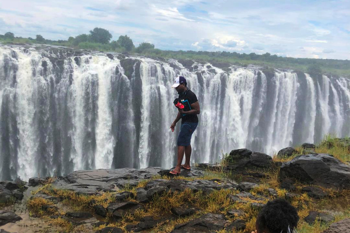 A man pictured at the edge of Victoria Falls before he fell to his death